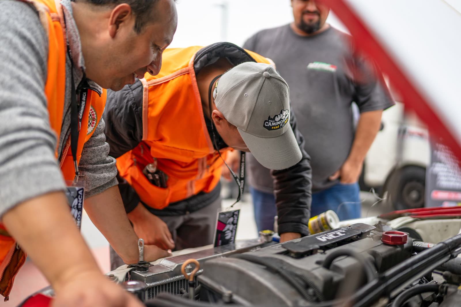 Technician inspecting an engine bay during a repair at Guerra Auto and Collision