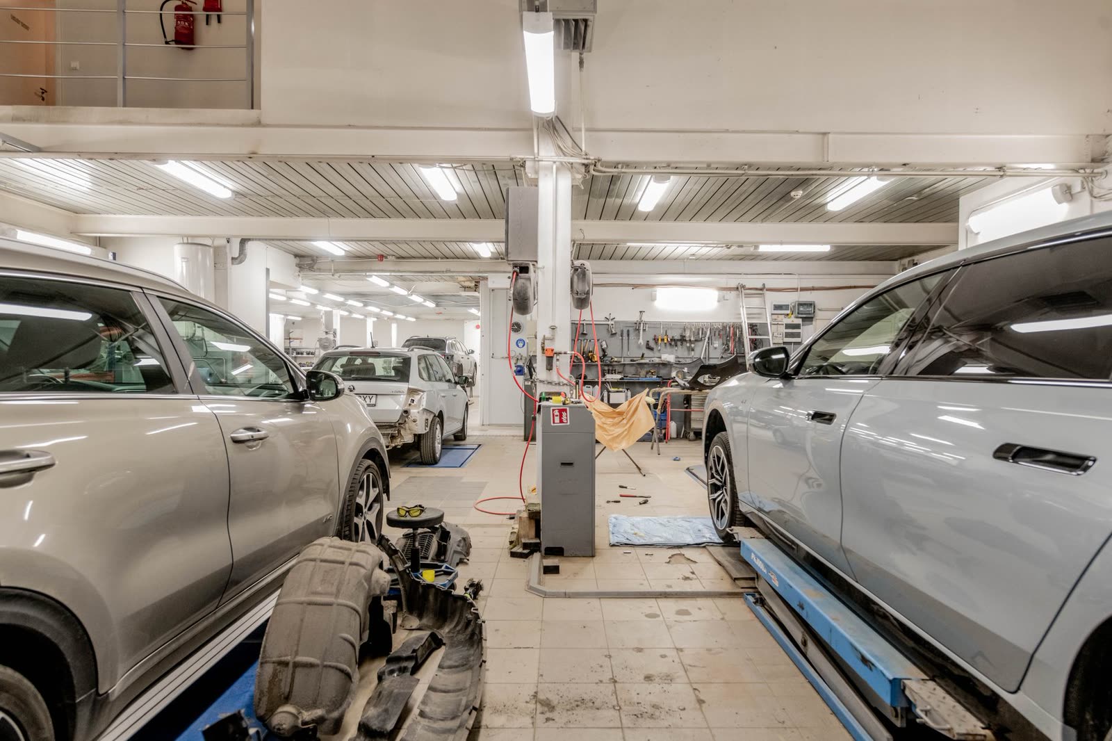 Auto repair bay with a car raised on the lift