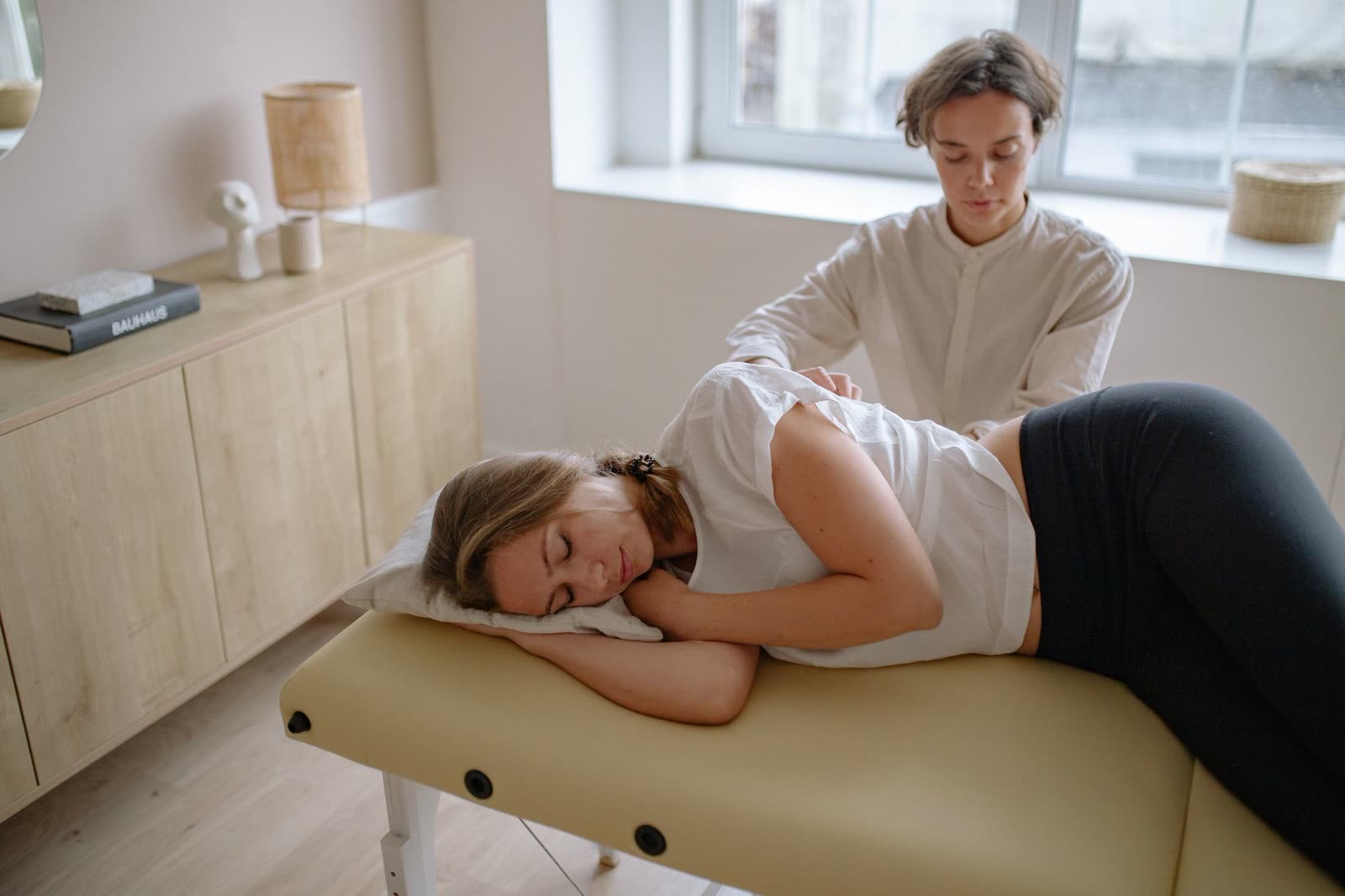 Follow-up spinal adjustment in progress on a treatment table
