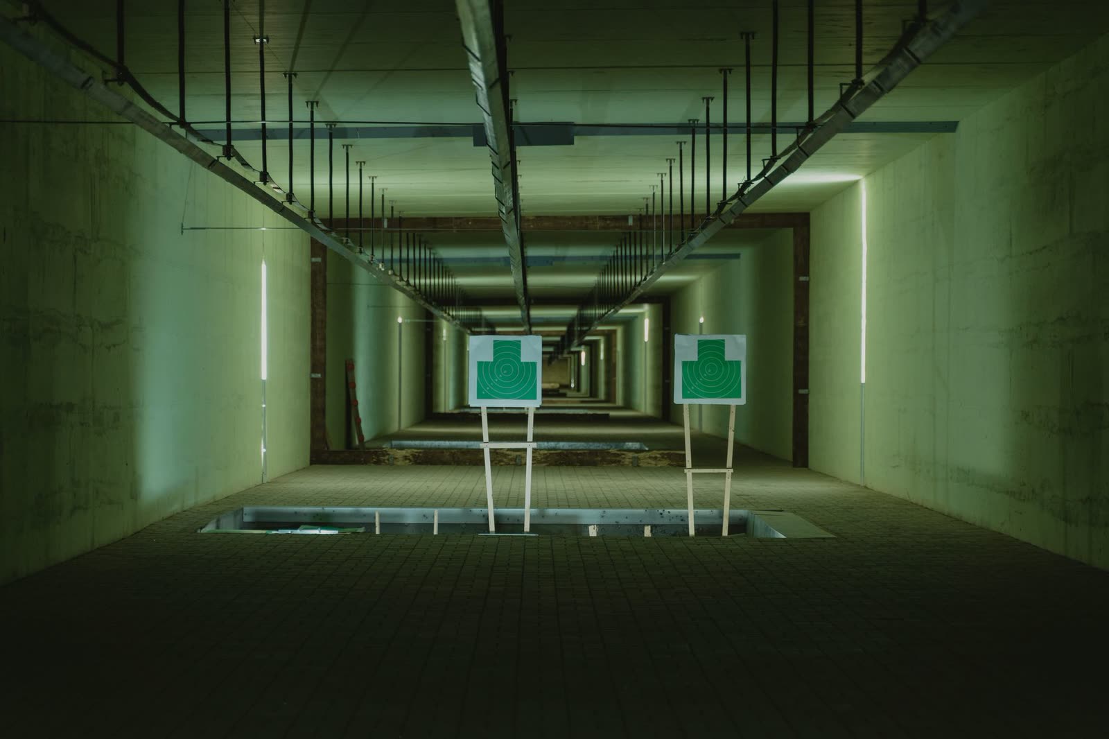 Empty indoor shooting range lane with target downrange