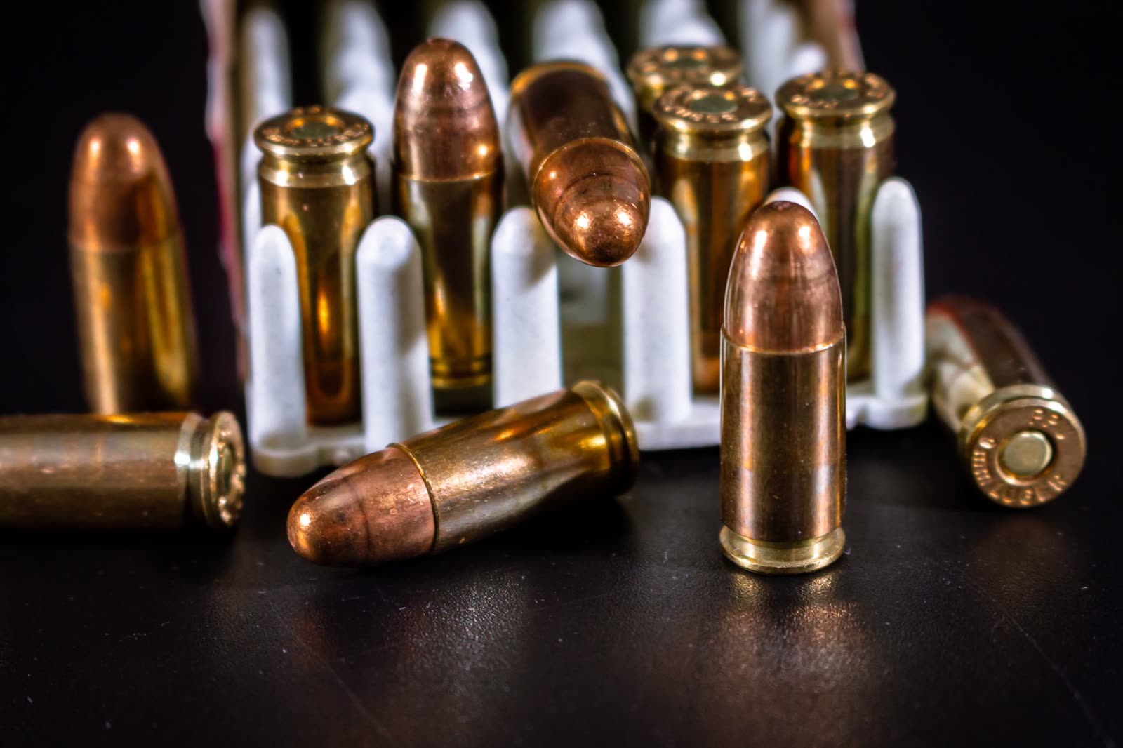 Boxes of 9mm and rifle ammunition stacked on a shelf