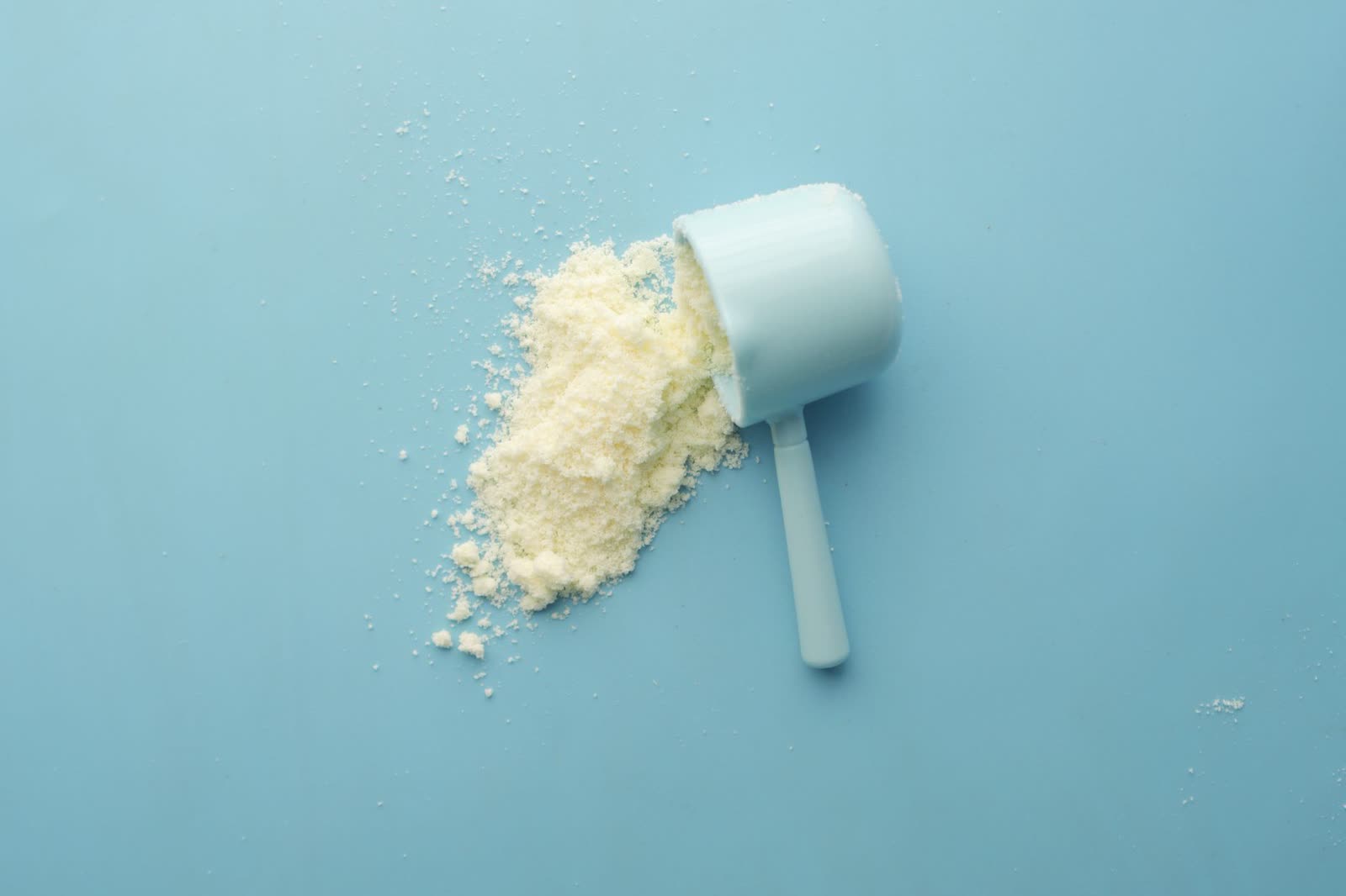 Whey Protein Subscription: grass-fed whey protein tub with a metal scoop
