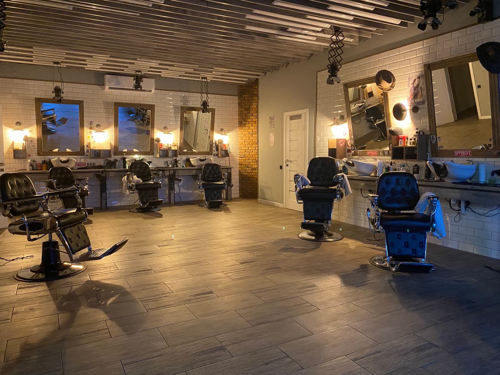 Clippers, guards and combs laid out along the barber counter